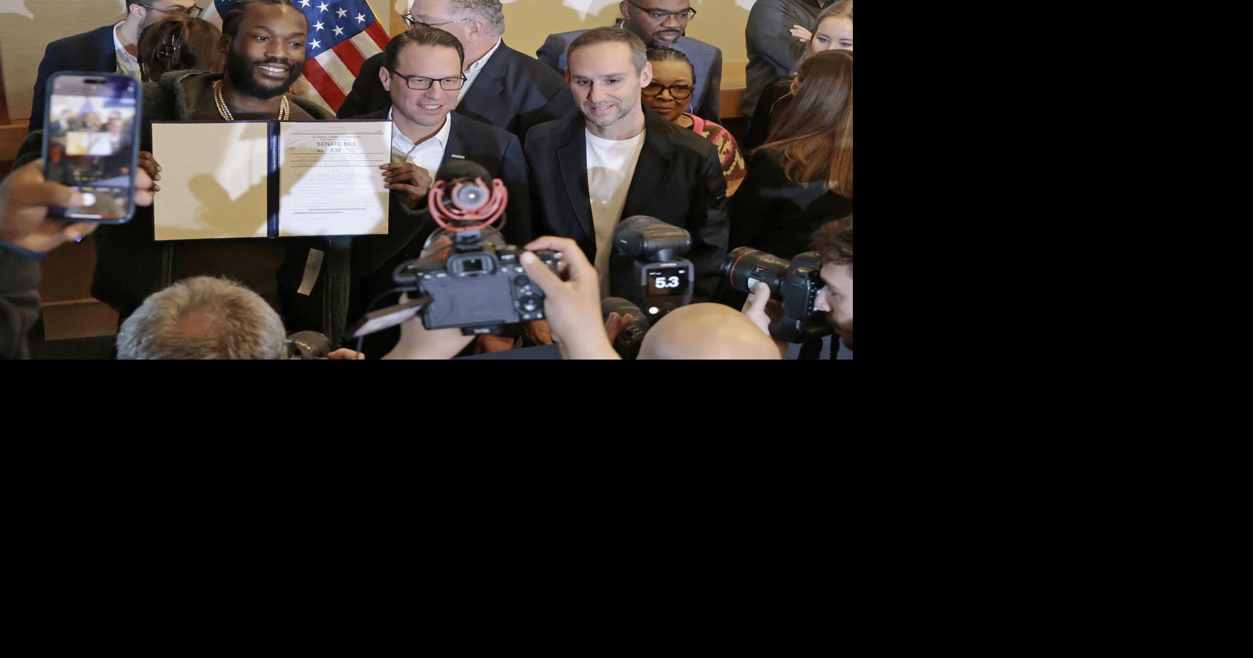 Josh Shapiro and Michael Rubin following the singing of the ceremonial bill celebrating landmark probation reform and clean slate legislation at the National Constitution Center in Philadelphia on Dec. 15, 2023.