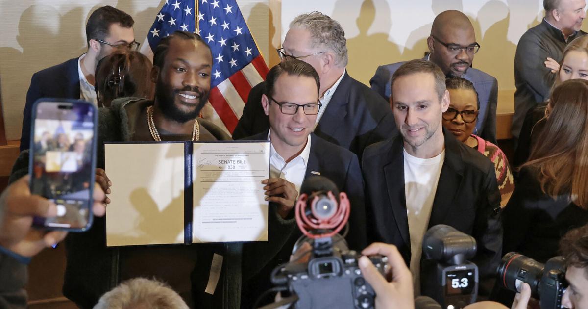 Josh Shapiro and Michael Rubin following the singing of the ceremonial bill celebrating landmark probation reform and clean slate legislation at the National Constitution Center in Philadelphia on Dec. 15, 2023.