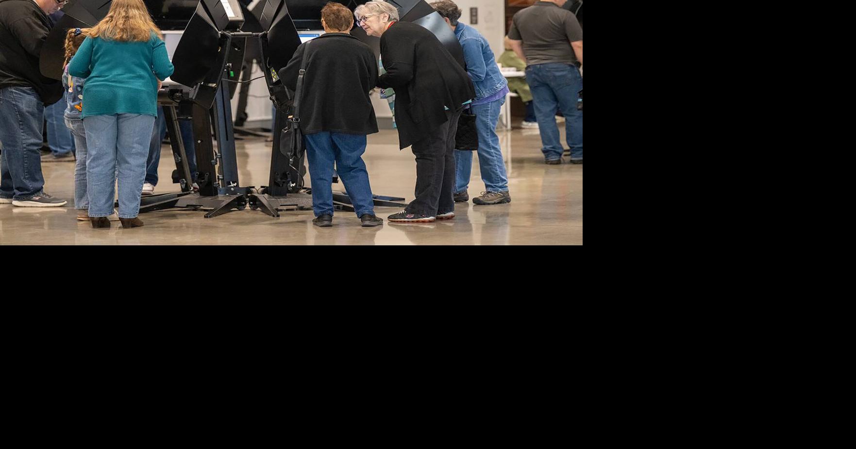 Voters cast their ballots on the first day of in-person advanced voting in Johnson County at he Arts and Heritage Center in Overland Park on Saturday, Oct. 19, 2024.