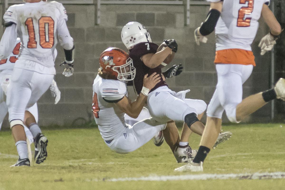 Paul Humphrey is wrapped up by Derek Pennington.JPG