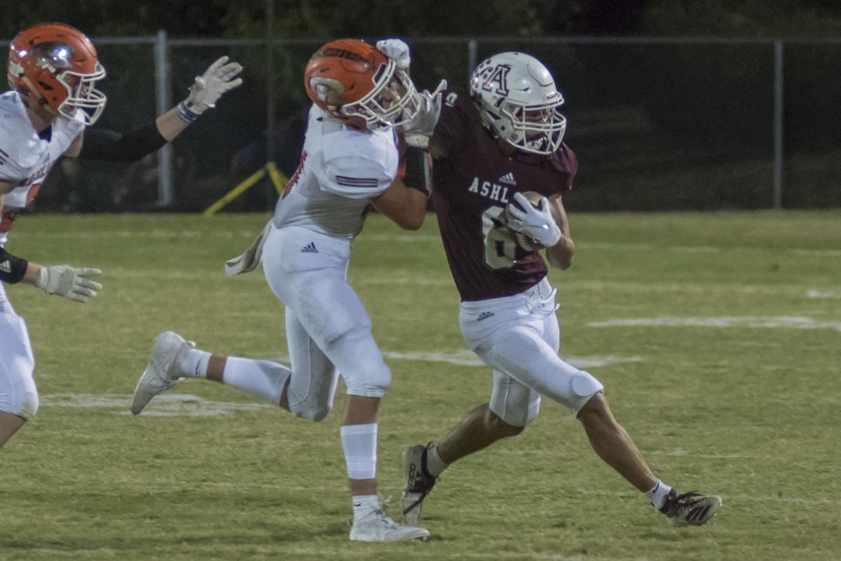 Blake Hester delivers a stiff arm as he gets the edge.JPG