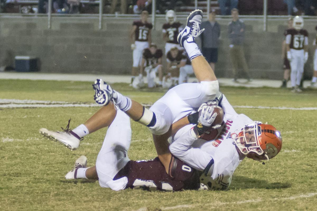 Gunnur Lewis is wrapped up by Camron Curtis.JPG
