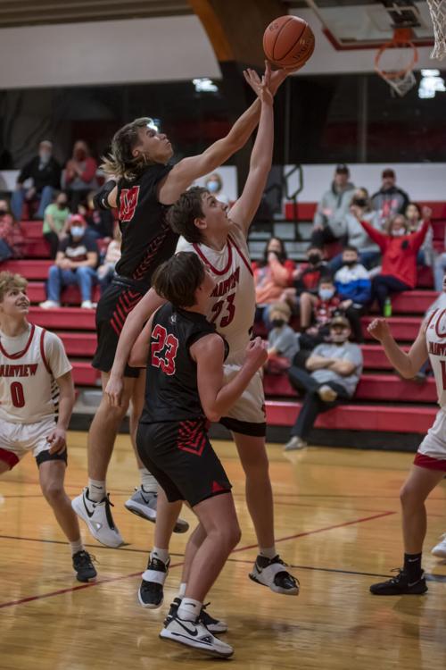L Steven Day going up for the shot as Trenton Adkins blocks the basket.JPG