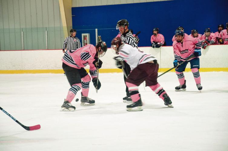 Field hockey players pause to 'support breast cancer awareness' at a recent  game 