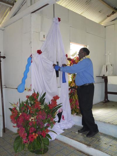 Minister of Health switches on solar lights for St. Luke's chapel