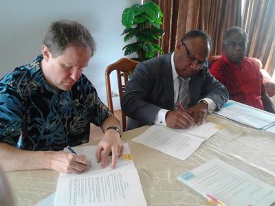 Finance Minister Maki Simelum ( r) World Bank Country Director Franz Drees-Gross (l) with Infrastructure Minister Esmon Sai ( far right)