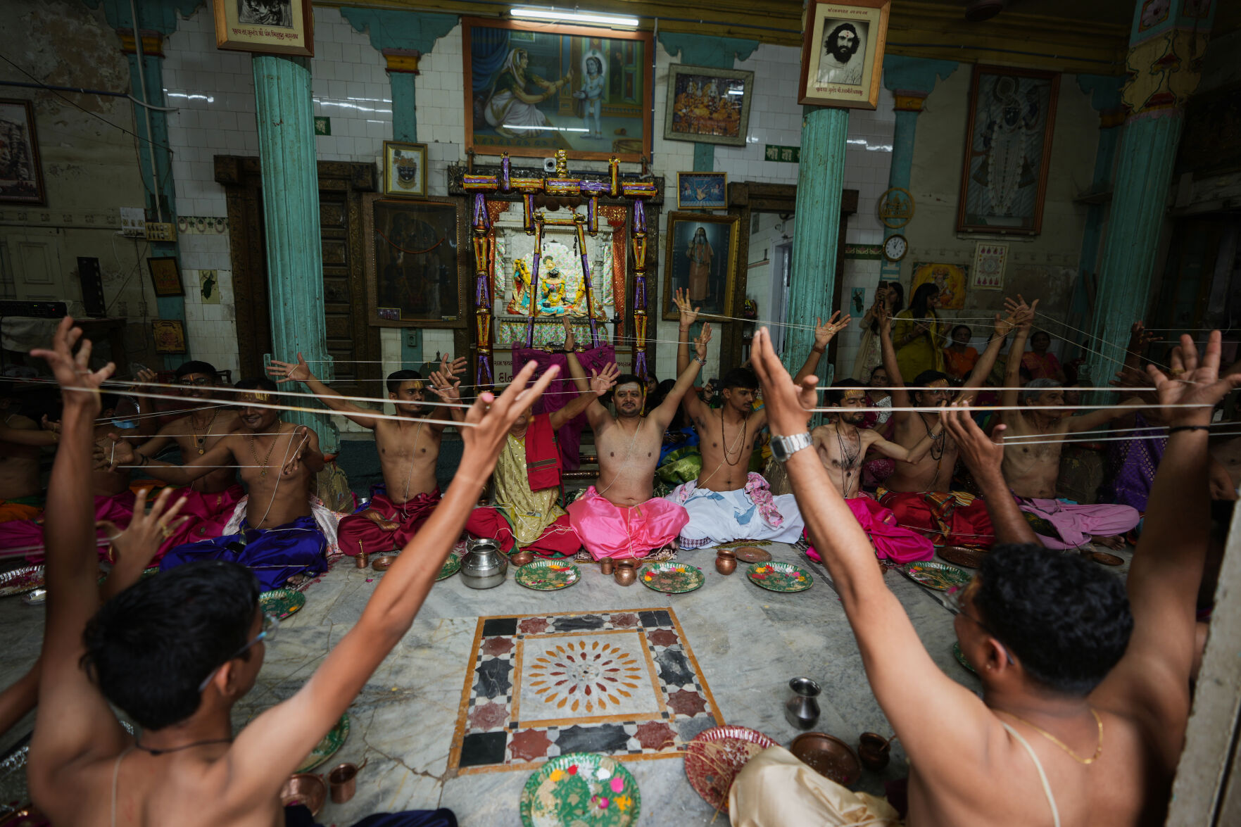 Hindu devotees change sacred thread during annual Upakarma ritual at Ahmedabad temple; event held Thursday, Aug. 27, 2026