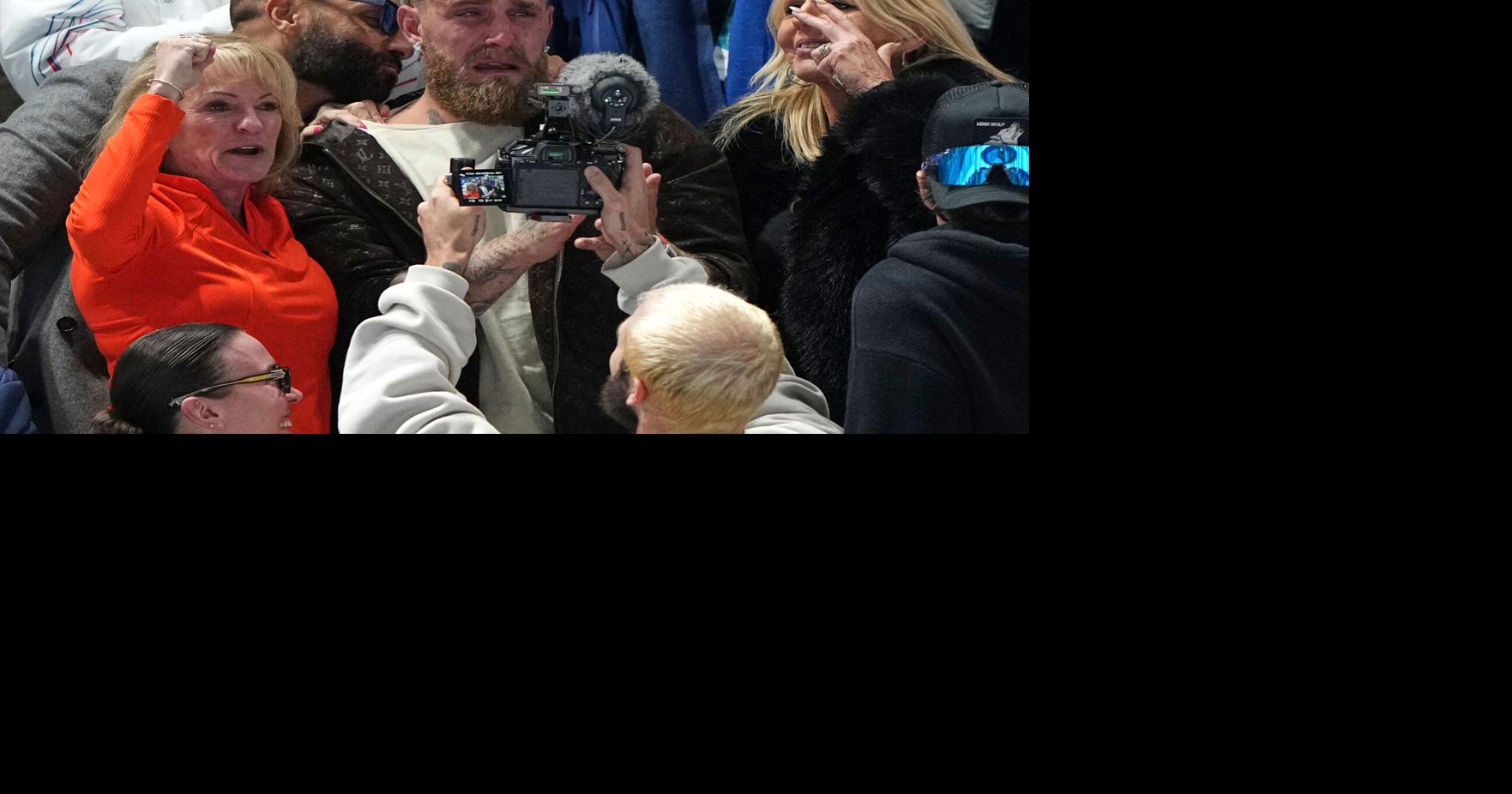 Jake Paul cheers from the second row as his fiancée, Jutta Leerdam, wins Olympic speedskating gold