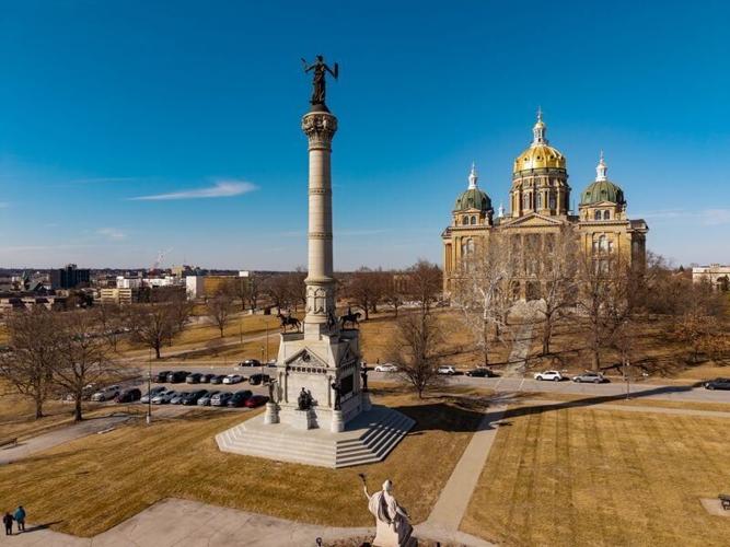 The Soldiers and Sailors Monument dedicated to Iowans who served in the Civil War towers over the grounds of the Iowa Capitol in Des Moines, topped by a statue of Victory.