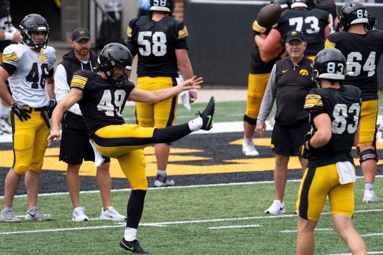 Iowa punter Boston Everitt (49) punts the football Aug. 15, 2026 during the Kids Day at Kinnick open practice at Kinnick Stadium