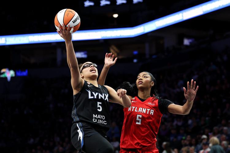 Minnesota Lynx guard Olivia Miles (5) works around Atlanta Dream forward Angel Reese (5) during the second half at Target Center.