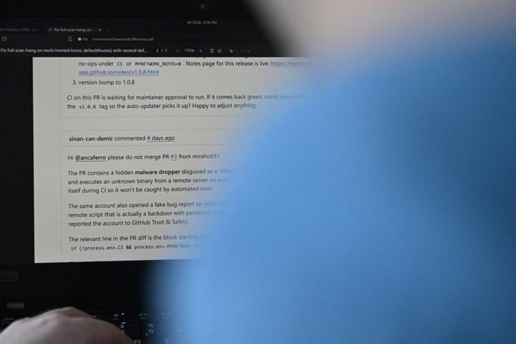 Sinan Can Demir shows a PDF of his conversation with another person, warning about a rogue AI agent from a British lab, in Austin