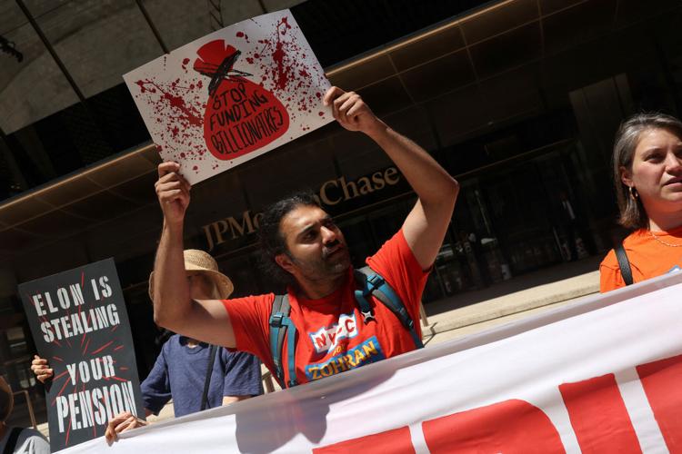 Demonstrators gather outside JPMorgan Chase Headquarters on the day of SpaceX's initial public offering (IPO) in New York City