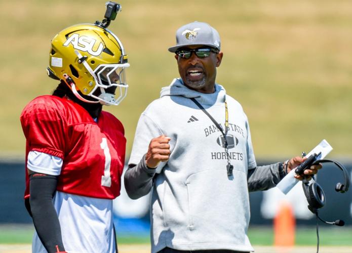 Head coach Eddie Robinson, Jr., works with quarterback Andrew Body (1) during an Alabama State University football scrimmage at ASU Stadium in Montgomery Ala., on Saturday August 16, 2025.