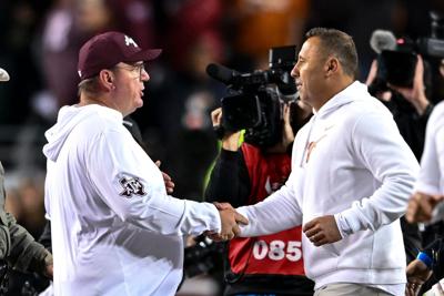 Nov 30, 2024; College Station, Texas, USA; Texas A&M Aggies head coach Mike Elko, left, shakes hands with Texas Longhorns head coach Steve Sarkisian after the game. The Longhorns defeated the Aggies 17-7. at Kyle Field. Mandatory Credit: Maria Lysaker-I...