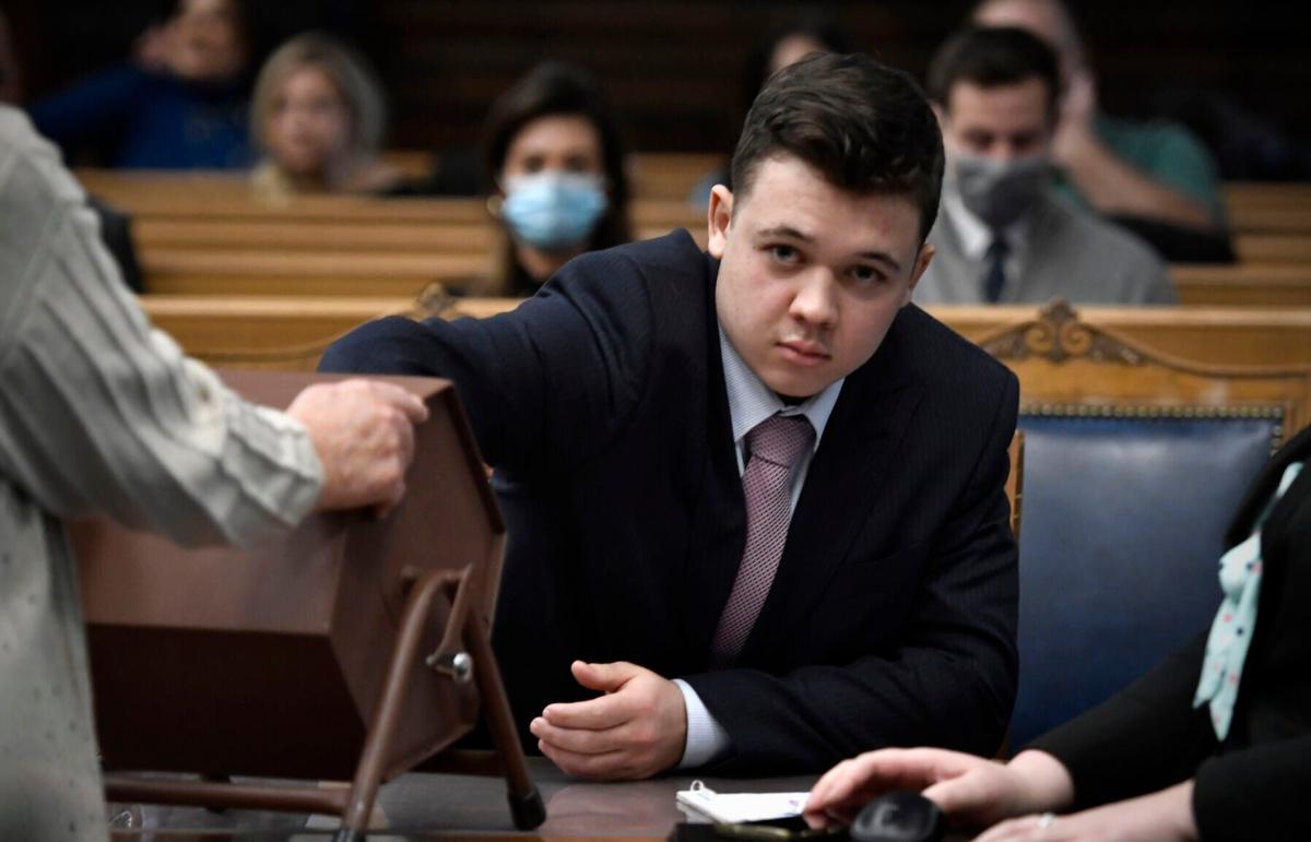 Kyle Rittenhouse pulls numbers of jurors out of a tumbler during his trial at the Kenosha County Courthouse on Tuesday, Nov. 16, 2021, in Kenosha, Wisconsin.