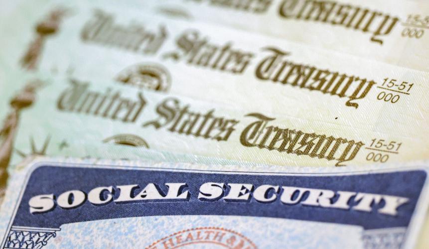 In this photo illustration, a Social Security card sits alongside checks from the U.S. Treasury on Oct. 14, 2021, in Washington, D.C..