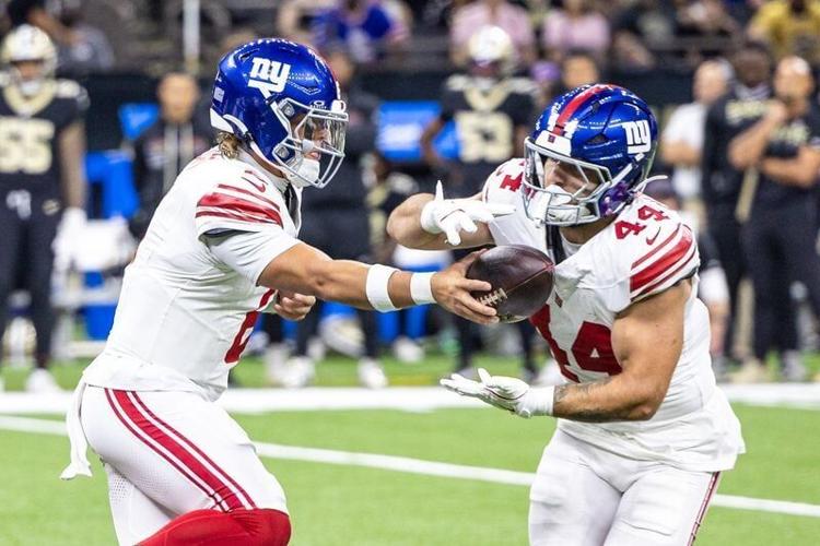 Oct 5, 2025; New Orleans, Louisiana, USA; New York Giants quarterback Jaxson Dart (6) hands off to running back Cam Skattebo (44) during the first half at Caesars Superdome.