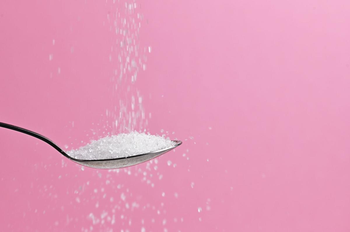 Sugar Pouring From A Spoon