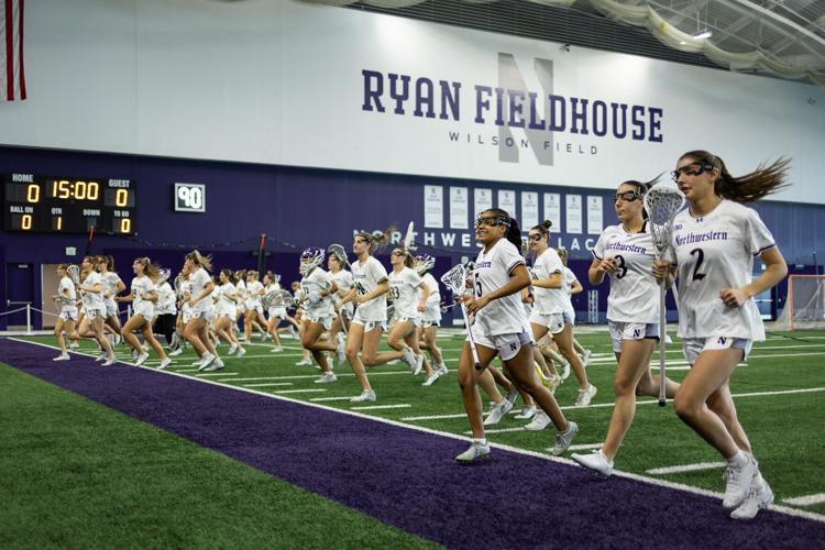Northwestern Wildcats players jog during warmups ahead of a women’ s lacrosse game against Central Michigan University in Evanston, Illinois, on Sunday, Feb. 15, 2026.