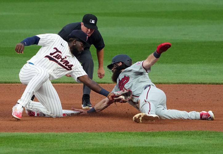 Minnesota Twins shortstop Kaelen Culpepper (12) tries to make the tag on Philadelphia Phillies left fielder Brandon Marsh (16)