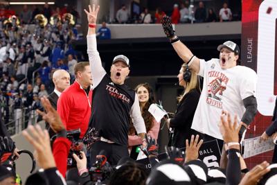 Texas Tech head coach Joey McGuire, left, and linebacker Ben Roberts, right, celebrate after their victory against BYU in the Big 12 Championship game at AT&T Stadium, Dec. 6, 2025, in Arlington, Texas.