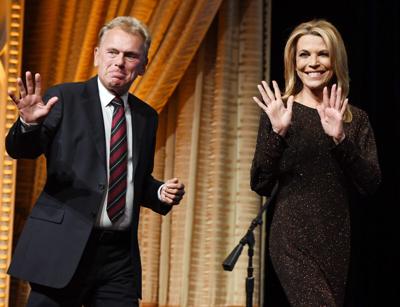 "Wheel of Fortune" host Pat Sajak and hostess Vanna White walk onstage as they are inducted into the National Association of Broadcasters Broadcasting Hall of Fame during the NAB Achievement in Broadcasting Dinner at the Encore Las Vegas on April 9, 201...