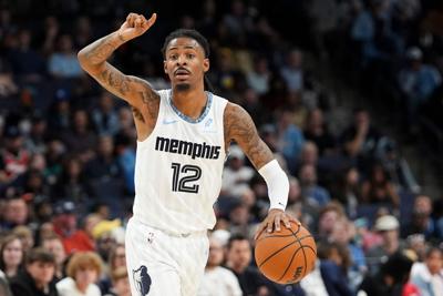 Grizzlies' Ja Morant (12) gestures to his teammates while he brings the ball up the court during the game between the Milwaukee Bucks and Memphis Grizzlies at FedExForum in Memphis, Tenn., on December 26, 2025.