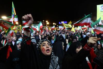 People chant during a rally in Tehran