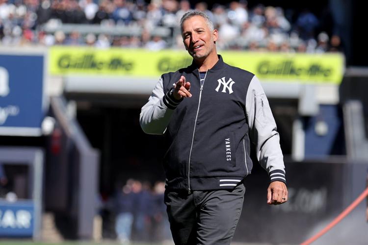 Former Yankees pitcher Andy Pettitte reacts after throwing out the ceremonial first pitch before an opening day game against the Milwaukee Brewers at Yankee Stadium.