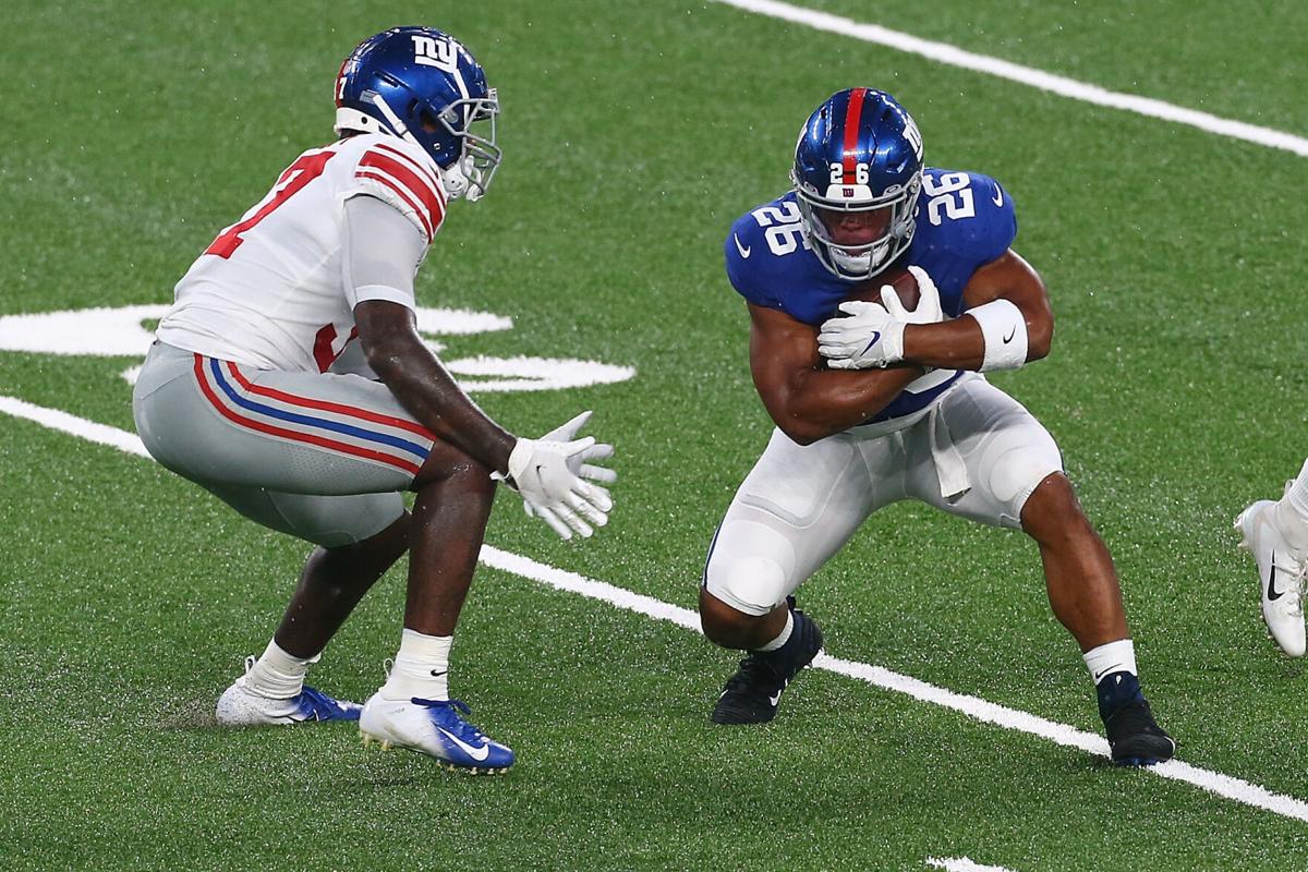 New York Giants running back Saquon Barkley carries the ball during the Blue and White scrimmage at MetLife Stadium in East Rutherford, New Jersey, on August 28, 2020.