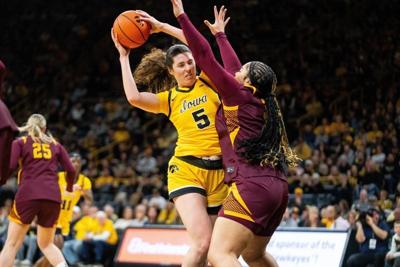 Iowa center Ava Heiden (5) keeps possession of the ball against Minnesota forward Finau Tonga (31) on Feb. 5, 2026, at Carver-Hawkeye Arena.