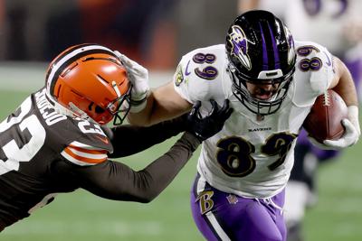Baltimore Ravens tight end Mark Andrews, right, stiff-arms the Cleveland Browns' Andrew Sendejo during the second quarter in the game at FirstEnergy Stadium in Cleveland on December 14, 2020.