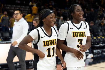 Iowa guard Chazadi 'Chit-Chat' Wright (11) and Iowa guard Dani Carnegie (3) react after the Hawkeyes defeated the Maryville