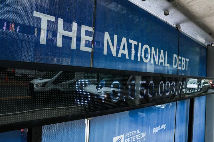 A sign displays national debt on a bus stop in the Foggy Bottom neighborhood of Washington, D.C., on Aug. 20, 2026.