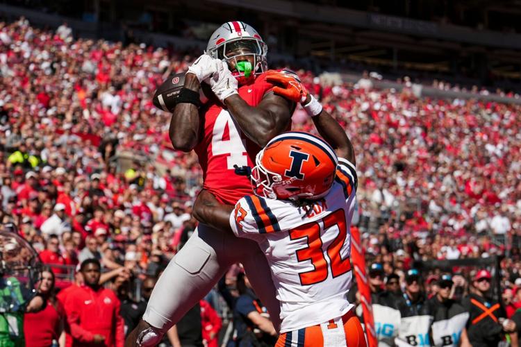 Ohio State Buckeyes wide receiver Jeremiah Smith (4) catches a touchdown over Illinois Fighting Illini defensive back Tywan Cox