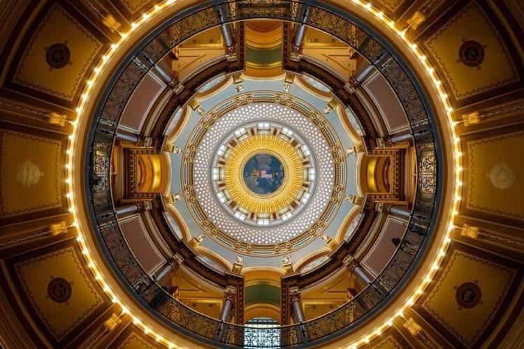 A lattice of piano wire supports a replica of a Grand Army of the Republic badge just below the ceiling of the Iowa Capitol.