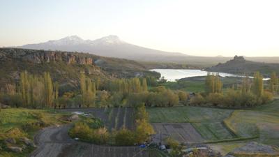 The snowy volcanic slopes of Mount Hasan's double peaks rule the horizon of Cappadocia, keeping watch over Güzelyurt.