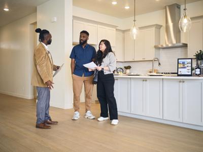 A professional real estate agent, showing a new home to prospective buyers.