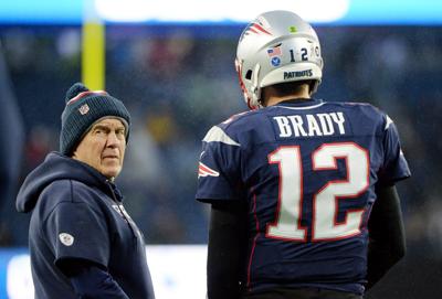 New England Patriots head coach Bill Belichick talks with quarterback Tom Brady before a game against the Dallas Cowboys on Nov. 24, 2019, in Foxborough, Massachusetts.