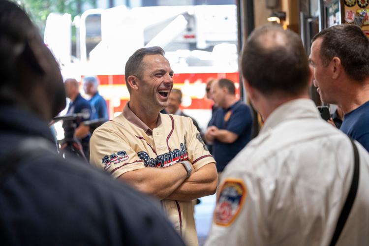 Retired New York Mets third basement David Wright chats with firefighters during an annual event where retired players from the