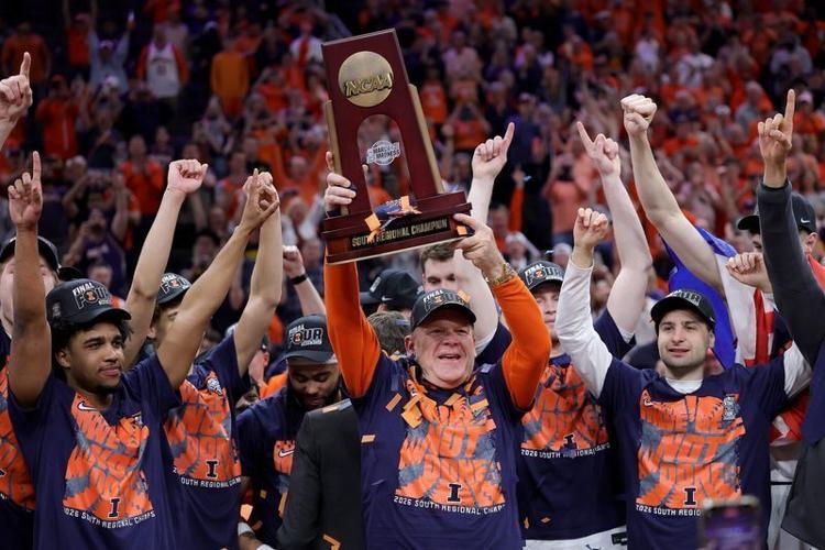 Head coach Brad Underwood of the Illinois Fighting Illini hoist the trophy with his team after defeating the Iowa Hawkeyes in the Elite Eight of the 2026 NCAA Men's Basketball Tournament at Toyota Center on March 28, 2026 in Houston, Texas.