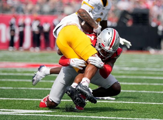 Ohio State Buckeyes cornerback Jermaine Mathews Jr. (7) tackles Kent State Golden Flashes wide receiver Ardell Banks (1) after a