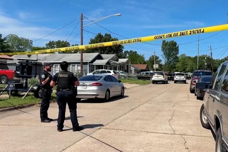 Police officers secure a street where eight children, with ages ranging from 1 to 14, were killed in a mass shooting in Shreveport, La. on April 19, 2026, in a still image from video.