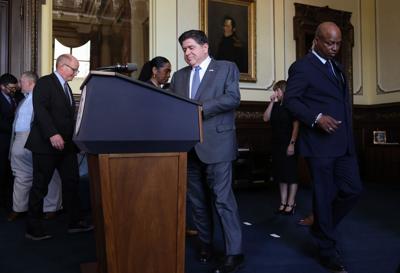 JB Pritzker, center, walks in with Senate President Don Harmon, left, and House Speaker Emanuel "Chris" Welch, right, for a news conference hours after the end of the spring legislative session at the State Capitol in Springfield, Ill., on Monday, June ...