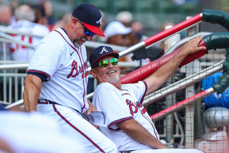 Sep 28, 2025; Cumberland, Georgia, USA; Atlanta Braves bench coach/infield coach Walt Weiss (4) and manager Brian Snitker (43) laugh in the dugout during the game against the Pittsburgh Pirates during the third inning at Truist Park. Mandatory Credit: Jord