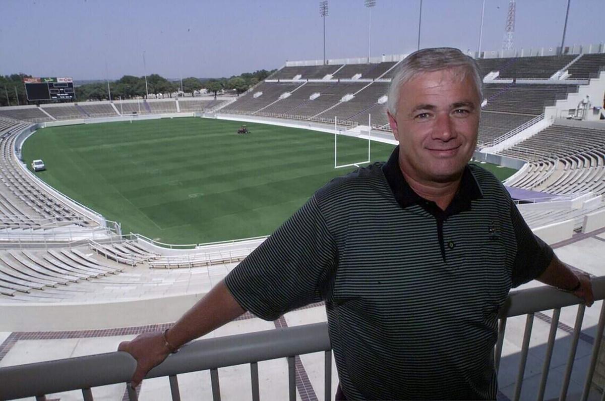 TCU head coach Dennis Franchione leans on the railing outside his office that overlooks the playing field at Amon G. Carter Stadium on Sept. 5, 2000, in Fort Worth, Texas.