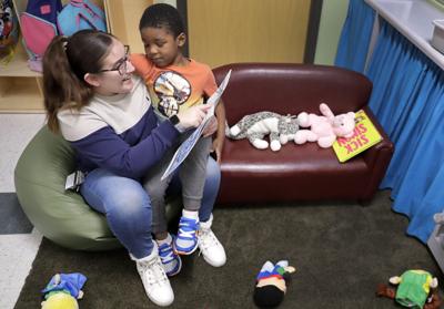Teaching assistant Anna Muniz reads a book together during a Head Start preschool class in Wisconsin on Thursday, April 4, 2024.