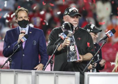 Tampa Bay Buccaneers head coach Bruce Arians holds the Lombardi Trophy as the team celebrates their 31-9 win in Super Bowl LV Sunday, February 7, 2021 in Tampa.