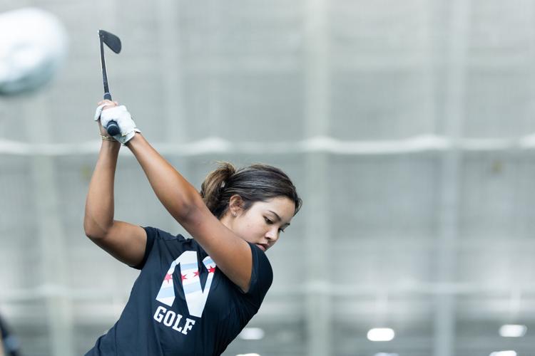 Northwestern Wildcats' Lauren E. Lee prepares her swing during a Northwestern women’ s golf practice at Ryan Fieldhouse in Evanston, Illinois, on Friday, Feb. 20, 2026.